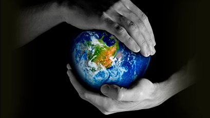 Two hands holding the earth on a black background.